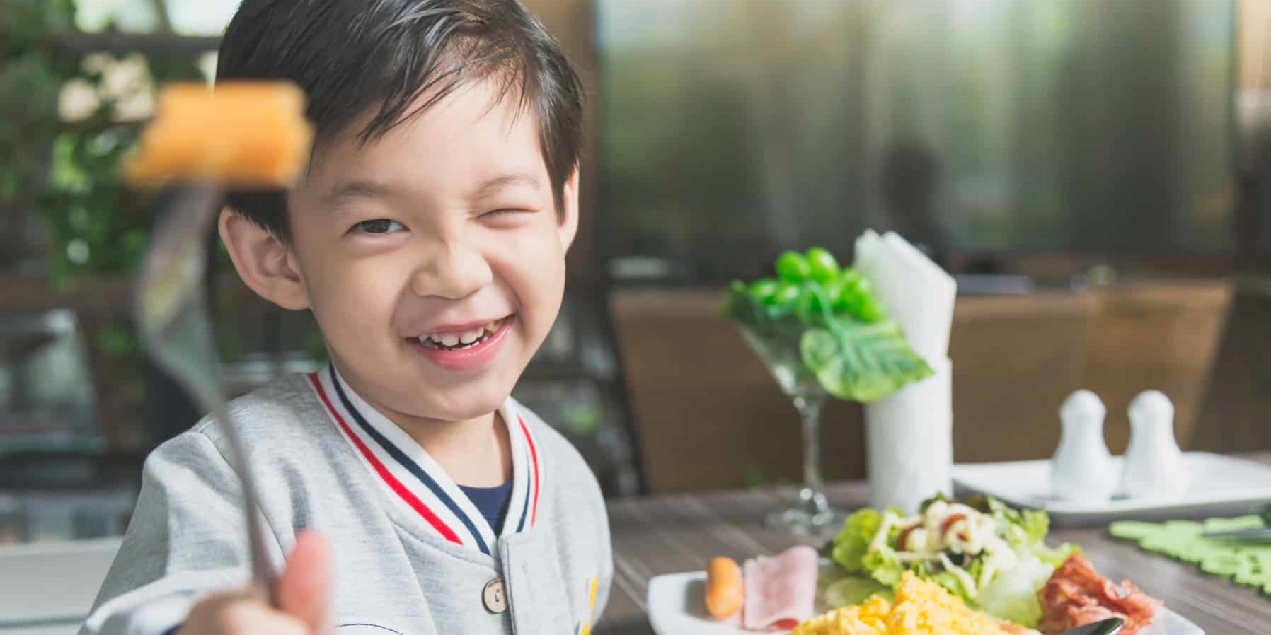 child eating keto breakfast child eating keto breakfast
